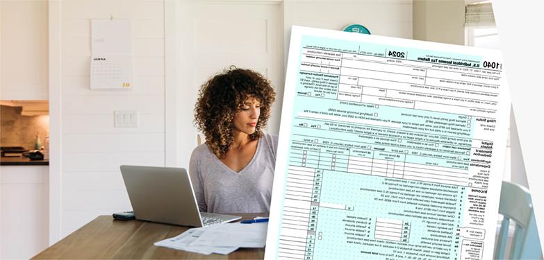 Woman doing taxes with computer, IRS form 1040, and USPS Priority Mail envelope.